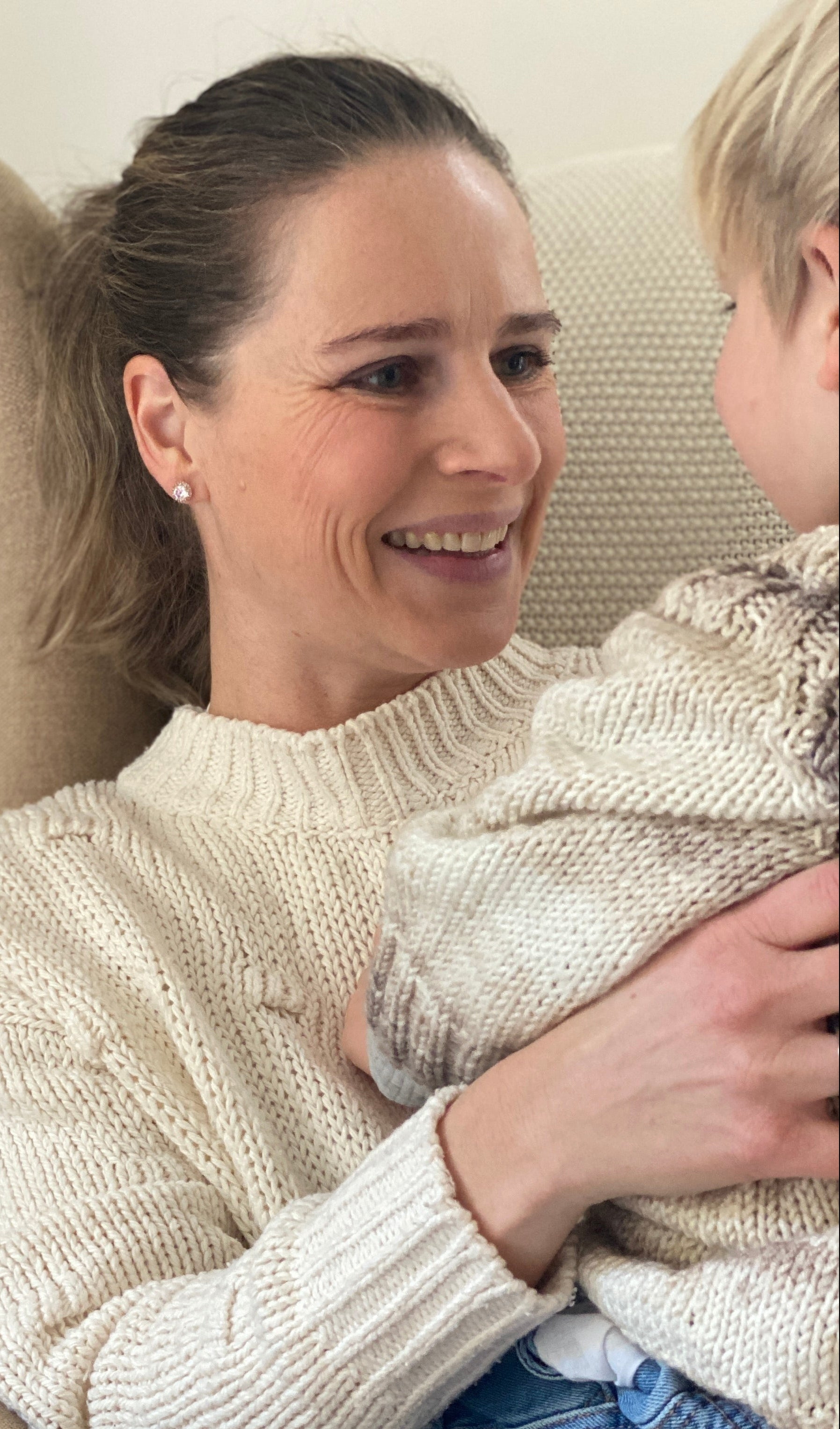 mother woman sitting with child on her lap in a livingroom setting